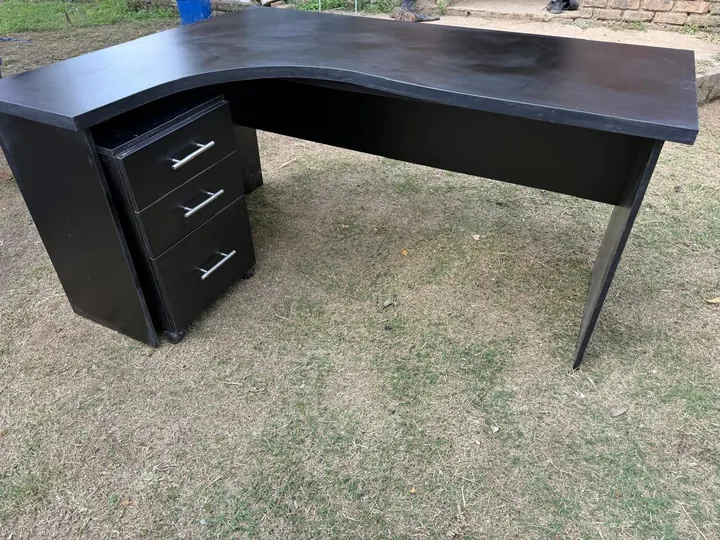 Black L-shaped desk with drawer pedestal