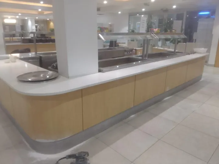 Curved oak-finish service counter in a commercial space