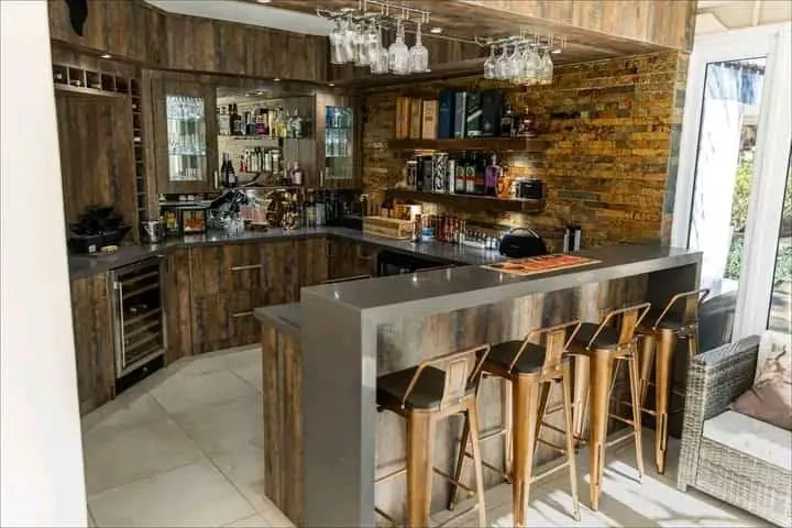 Rustic timber-finish kitchen with bar counter and stools