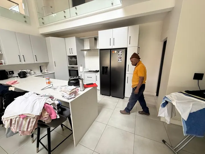 White kitchen units and island at installation stage