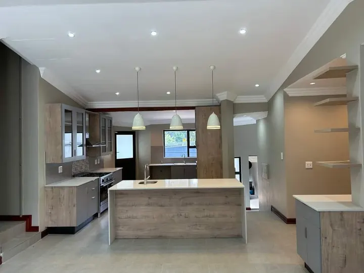 Open-plan kitchen with island and pendant lights